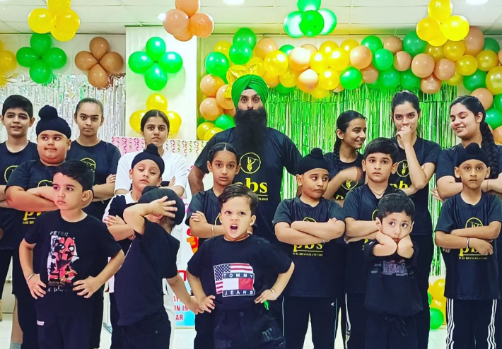 Our Bhangra instructor striking a pose with his students for a photo.